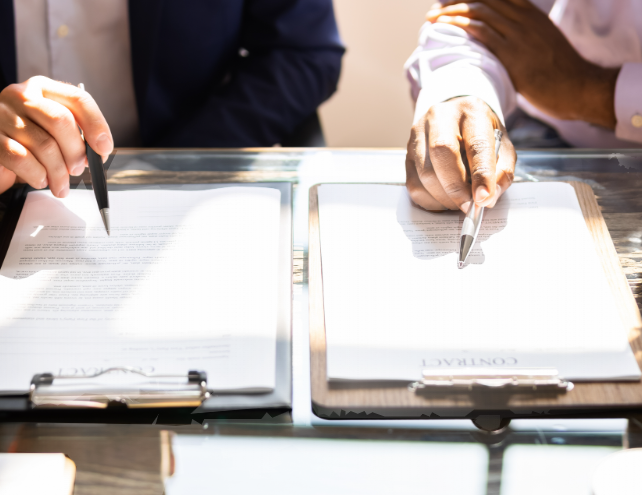 Two business people reviewing contract details